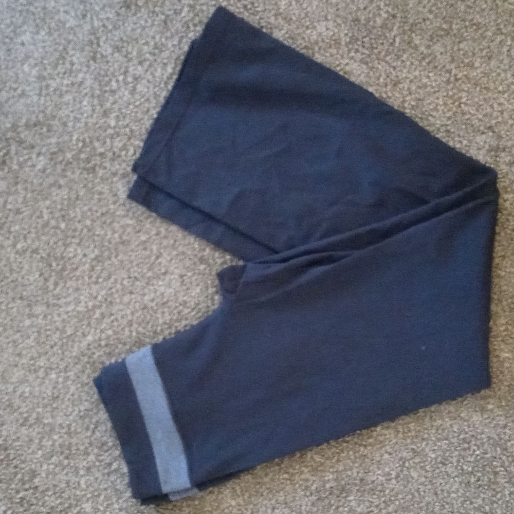 A pair of womens yoga pants with gray stipe around top